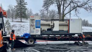 Image of the new laser being unloaded from the trailer that delivered it